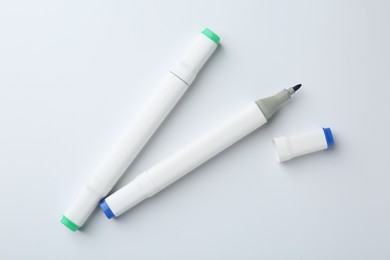 Colorful double sided markers on white background, flat lay