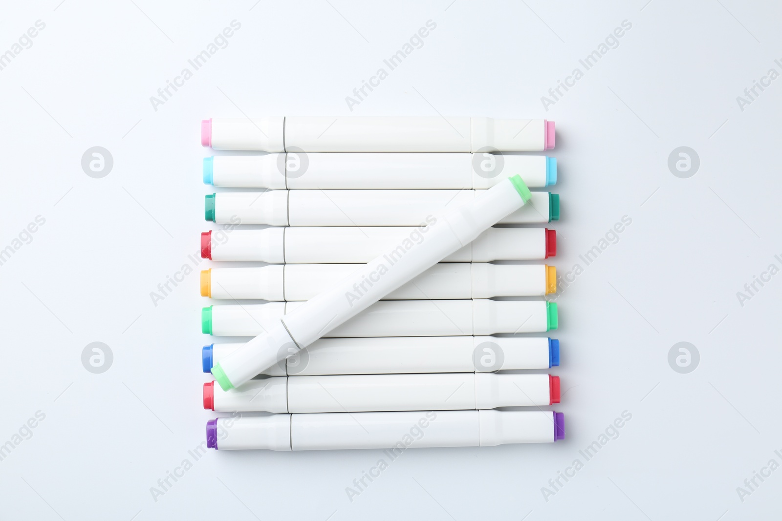 Photo of Colorful double sided markers on white background, flat lay