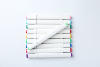 Colorful double sided markers on white background, flat lay