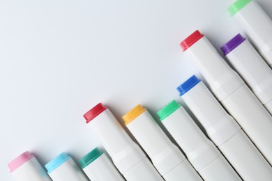 Photo of Colorful markers on white background, flat lay. Space for text