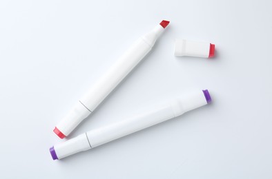 Colorful double sided markers on white background, flat lay