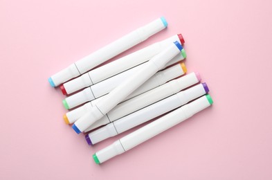 Photo of Colorful double sided markers on pink background, flat lay