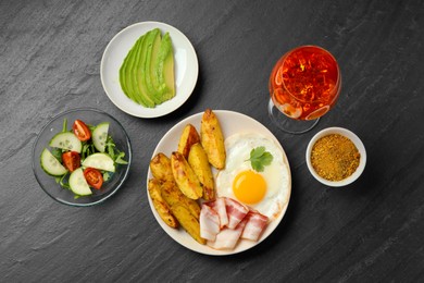 Photo of Flat lay composition with tasty brunch on dark textured table