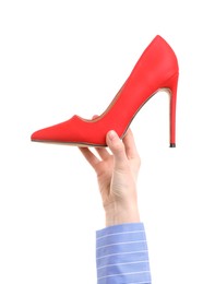 Woman with high heeled shoe on white background, closeup