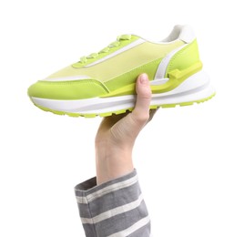 Photo of Woman with stylish green sneaker on white background, closeup