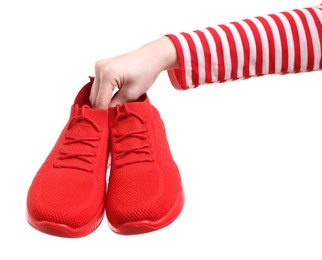 Woman with stylish red sneakers on white background, closeup