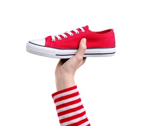 Photo of Woman with stylish red sneaker on white background, closeup