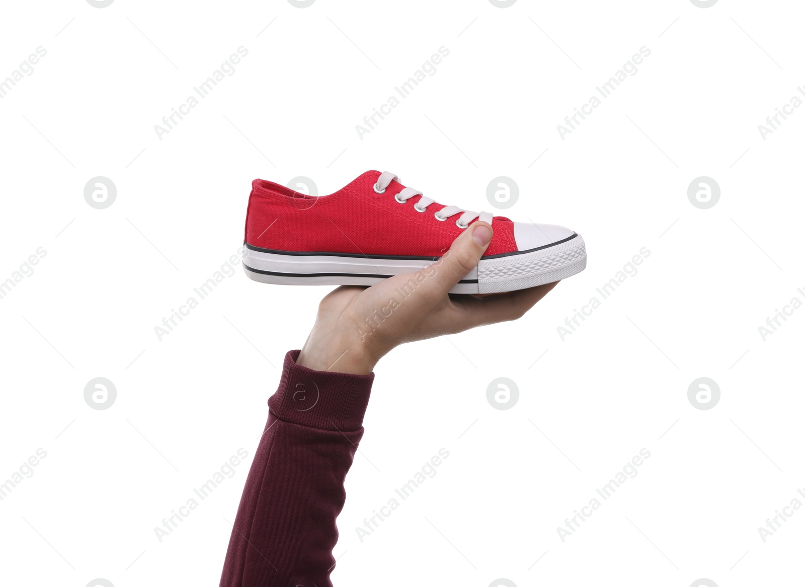 Photo of Man with stylish sneaker on white backpack, closeup