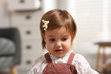 Photo of Portrait of sad baby girl at home