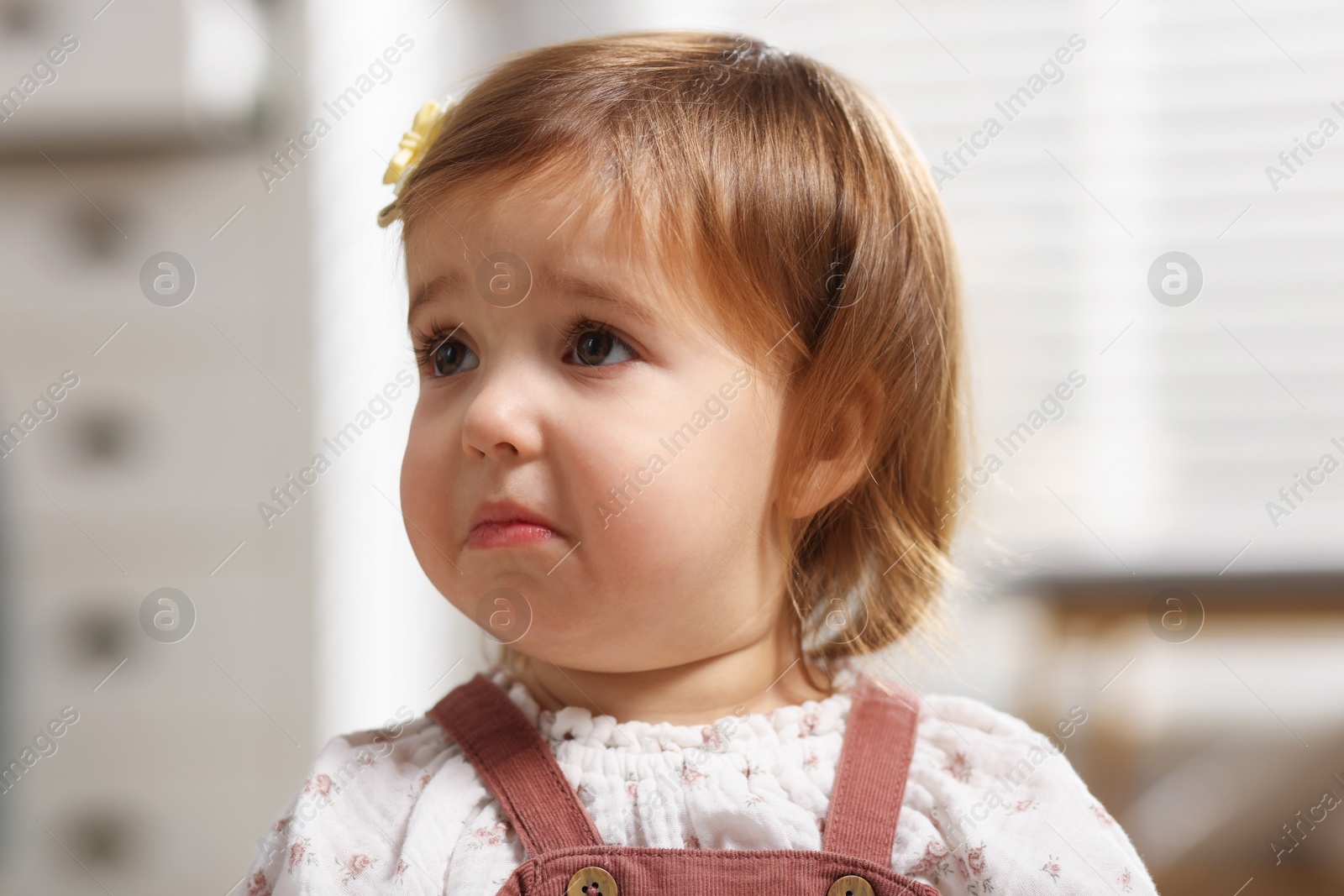 Photo of Portrait of sad baby girl at home