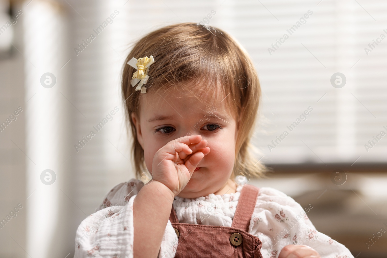 Photo of Cute little baby girl crying at home