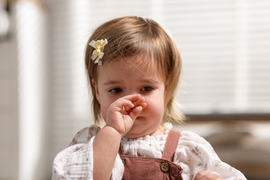 Photo of Cute little baby girl crying at home