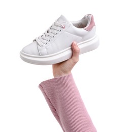 Woman with stylish sneaker on white background, closeup