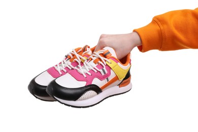 Photo of Woman with stylish colorful sneakers on white background, closeup