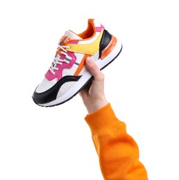 Photo of Woman with stylish colorful sneaker on white background, closeup