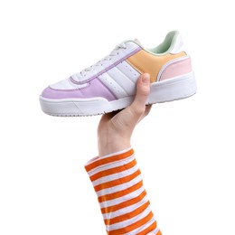 Photo of Woman with stylish colorful sneaker on white background, closeup