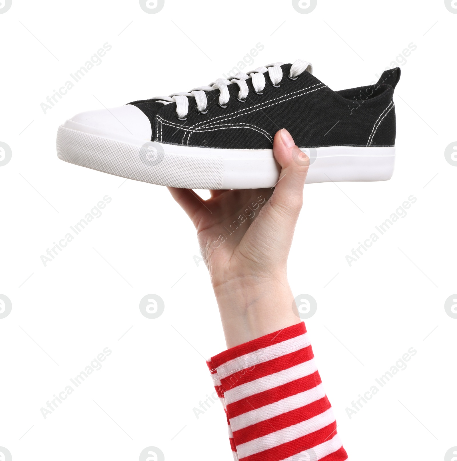 Woman with stylish black sneaker on white background, closeup Photo of Woman with stylish black sneaker on white background, closeup