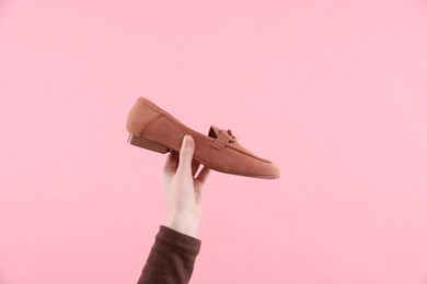 Photo of Woman with stylish shoe on pink background, closeup