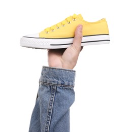 Man with stylish sneaker on white background, closeup