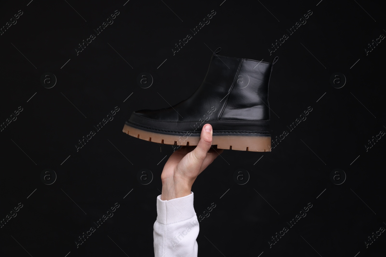 Photo of Man with stylish shoe on black background, closeup