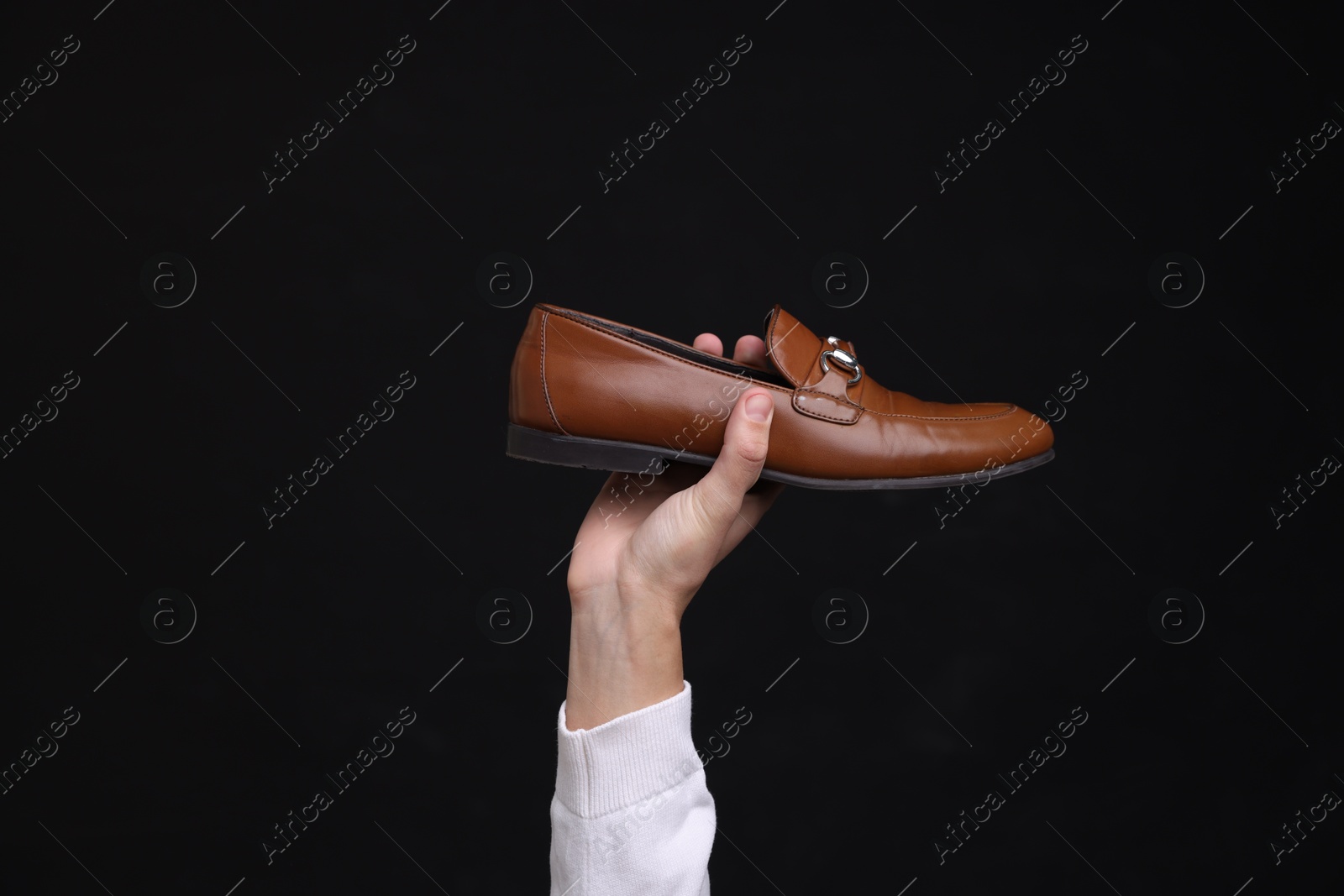 Photo of Man with stylish shoe on black background, closeup