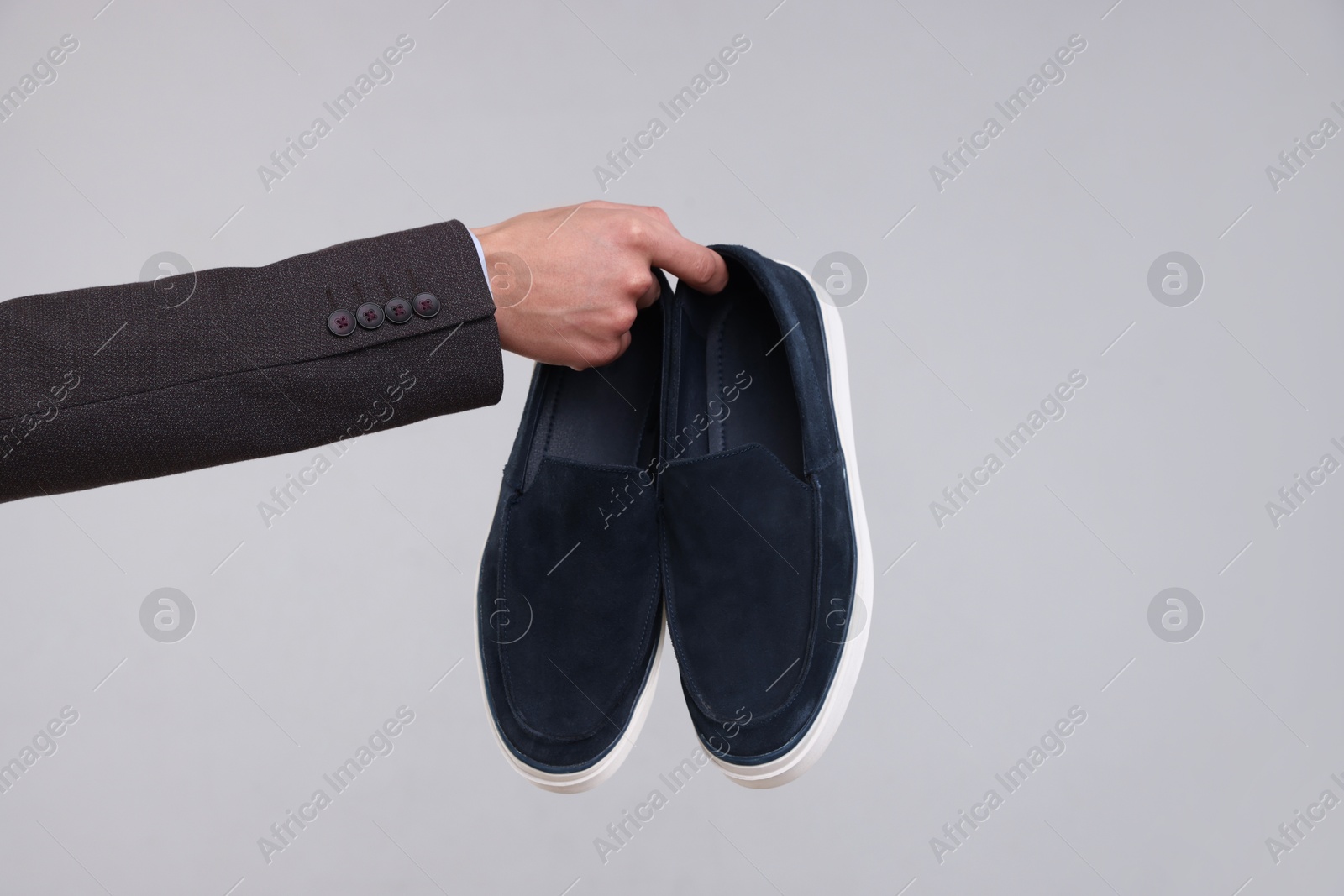 Photo of Man with stylish shoes on grey background, closeup