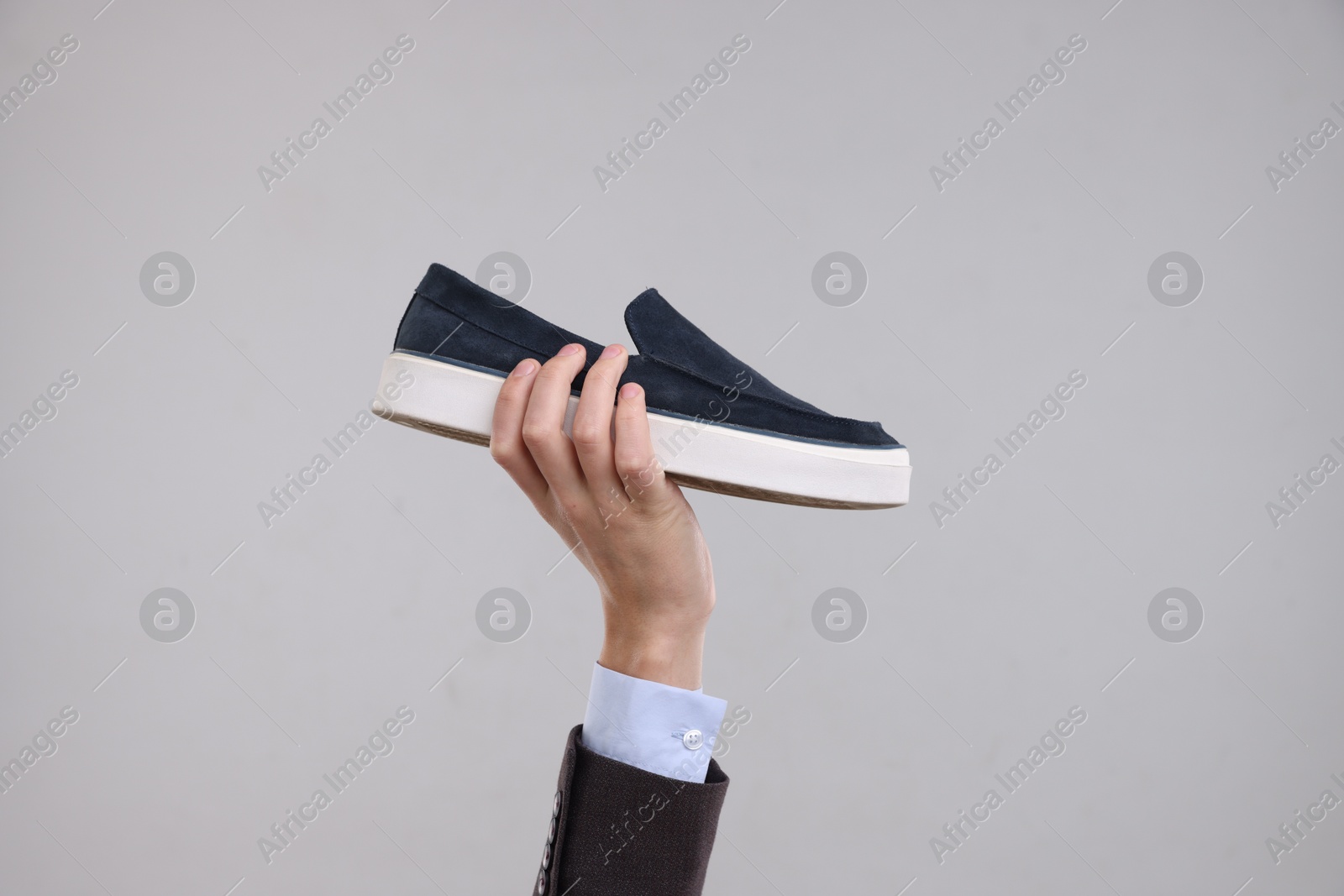 Photo of Man with stylish shoe on grey background, closeup