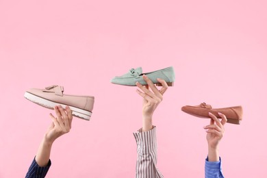 Photo of Women with different stylish shoes on pink background, closeup