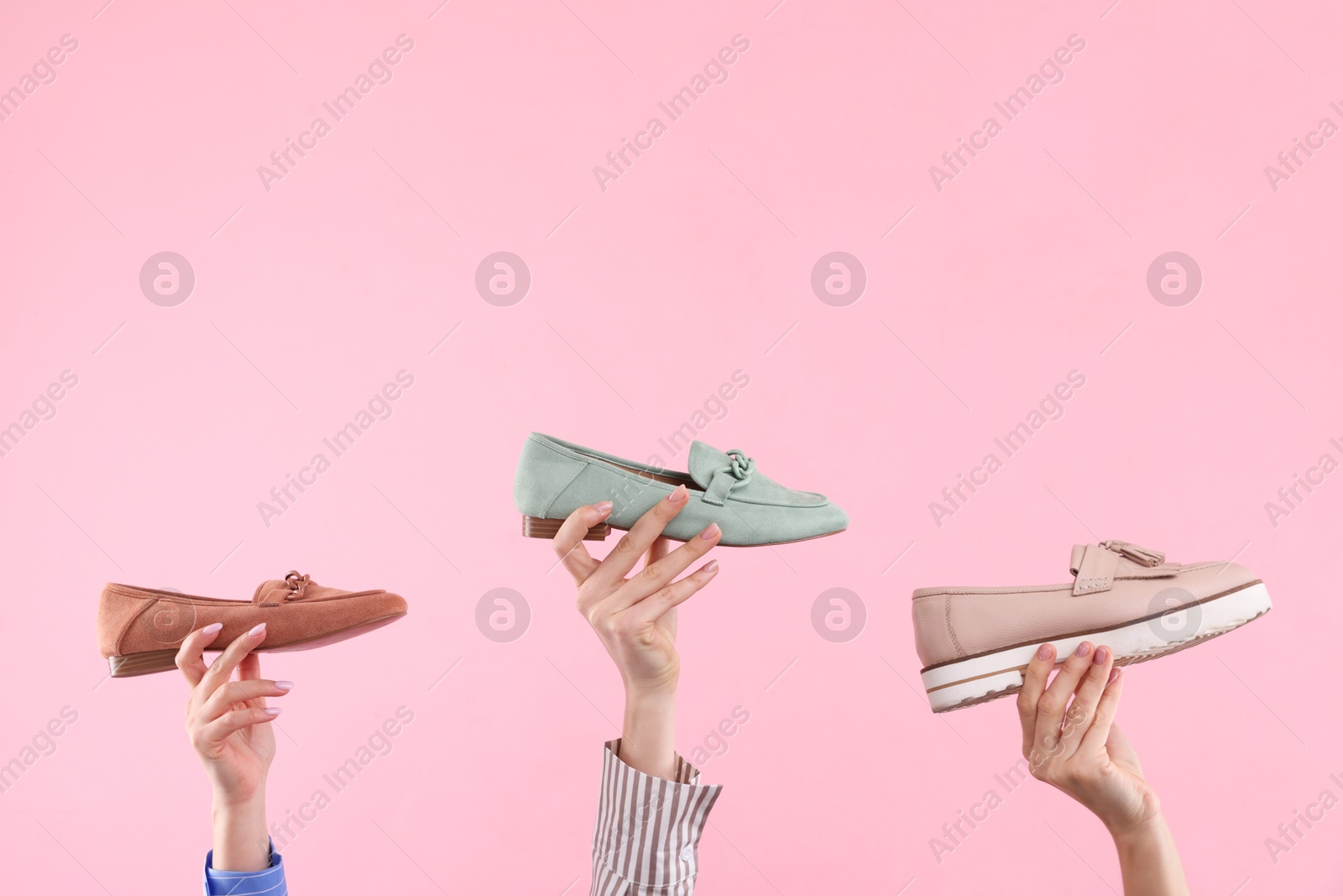 Photo of Women with different stylish shoes on pink background, closeup. Space for text