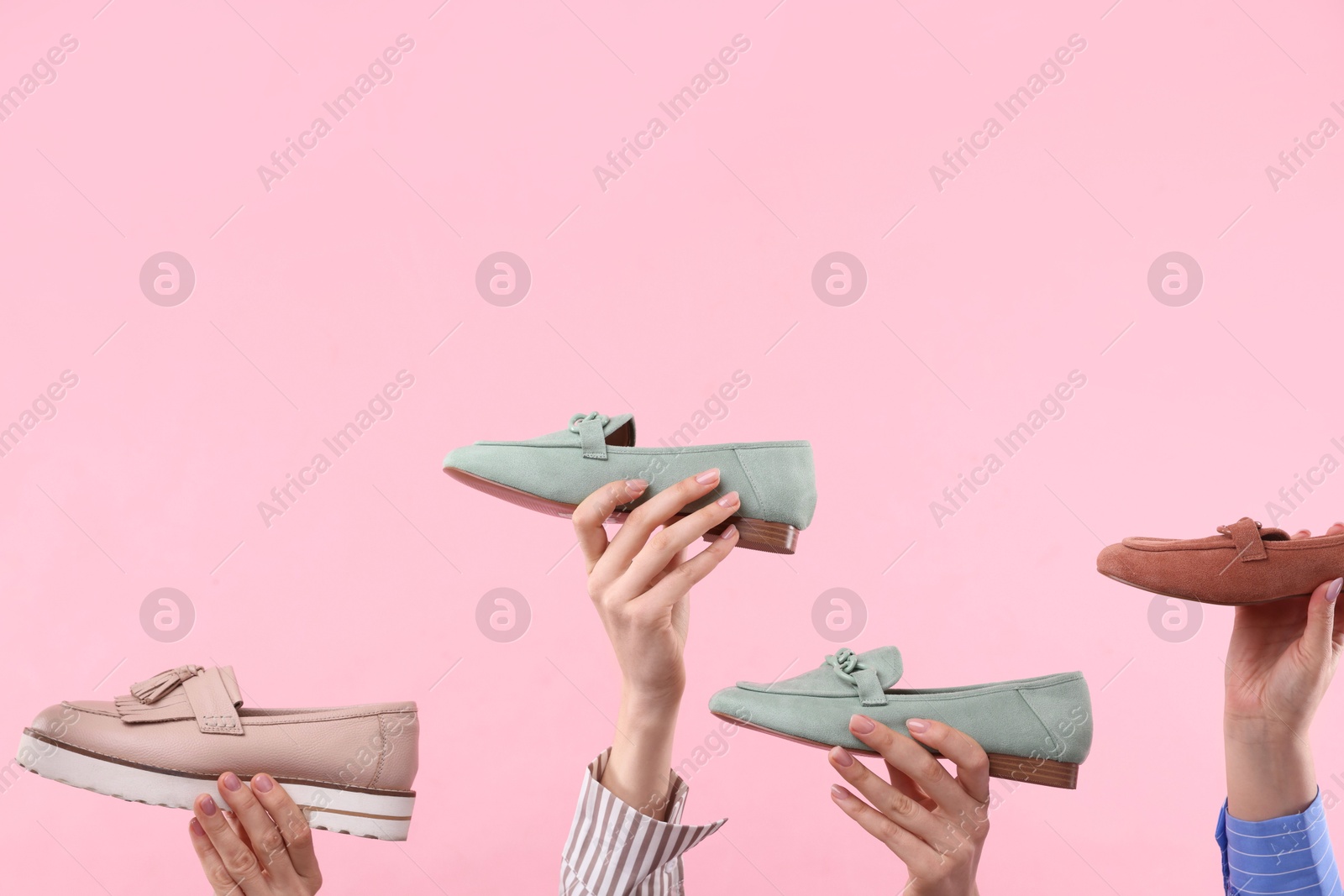 Photo of Women with different stylish shoes on pink background, closeup. Space for text