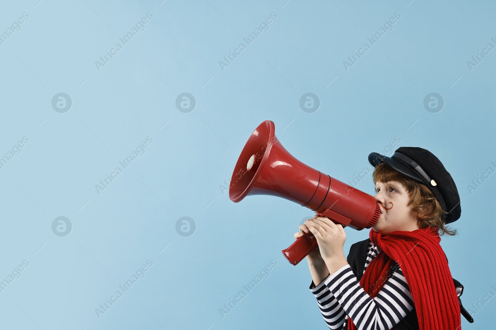 Photo of Cute boy in mime costume with megaphone on light blue background, space for text. Surprise party