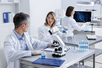 Scientists working with samples at table in laboratory