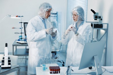 Photo of Scientists working with reagents and blood samples in laboratory