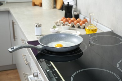 Photo of Cooking tasty egg on frying pan in kitchen, closeup