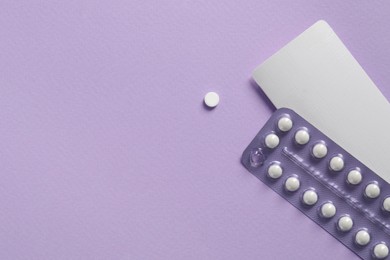 Photo of Blister of contraceptive pills and package on lilac background, top view. Space for text