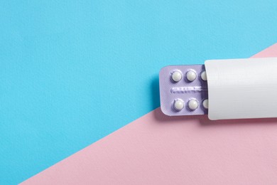 Photo of Blister of contraceptive pills in package on color background, top view. Space for text
