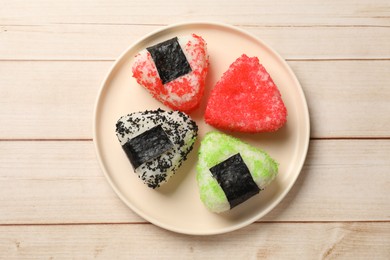 Photo of Tasty tobiko onigiri (Japanese rice balls) on white wooden table, top view