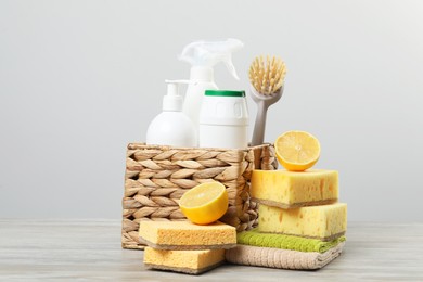 Photo of Eco-friendly cleaning products and supplies on wooden table