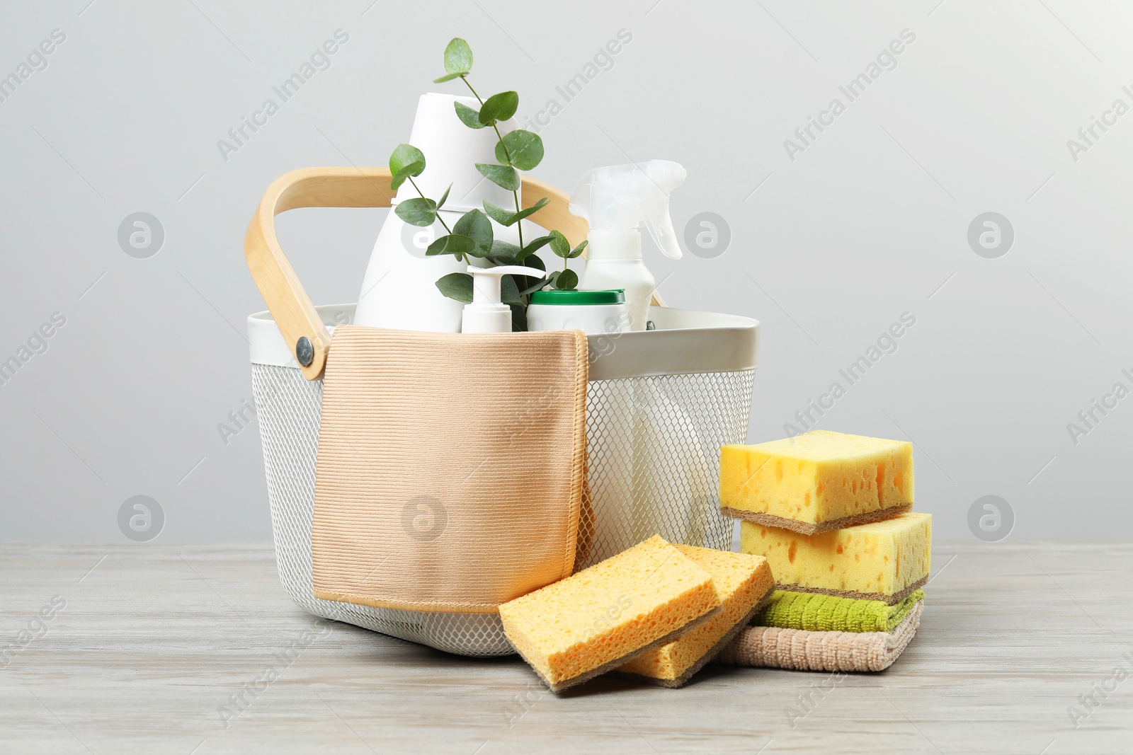 Photo of Eco-friendly cleaning products, supplies and eucalyptus branches on wooden table