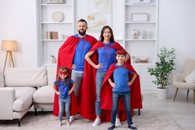 Photo of Parents and their children wearing superhero costumes at home