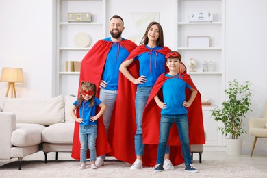 Photo of Parents and their children wearing superhero costumes at home