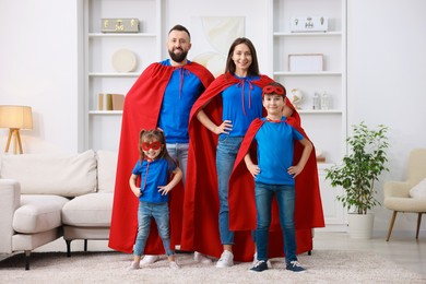 Photo of Parents and their children wearing superhero costumes at home