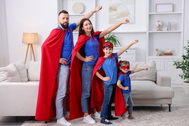 Photo of Parents and their children wearing superhero costumes at home