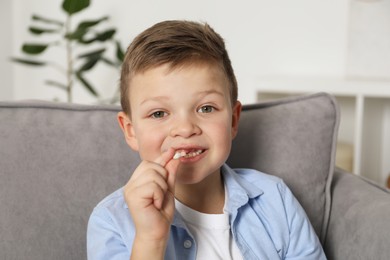 Photo of Cute little boy with missing tooth at home. Waiting for tooth fairy