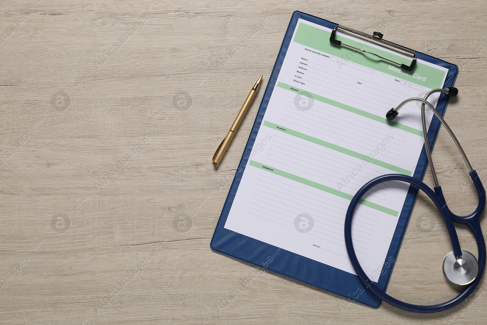 Photo of Medical card form, pen and stethoscope on light wooden background, top view. Space for text