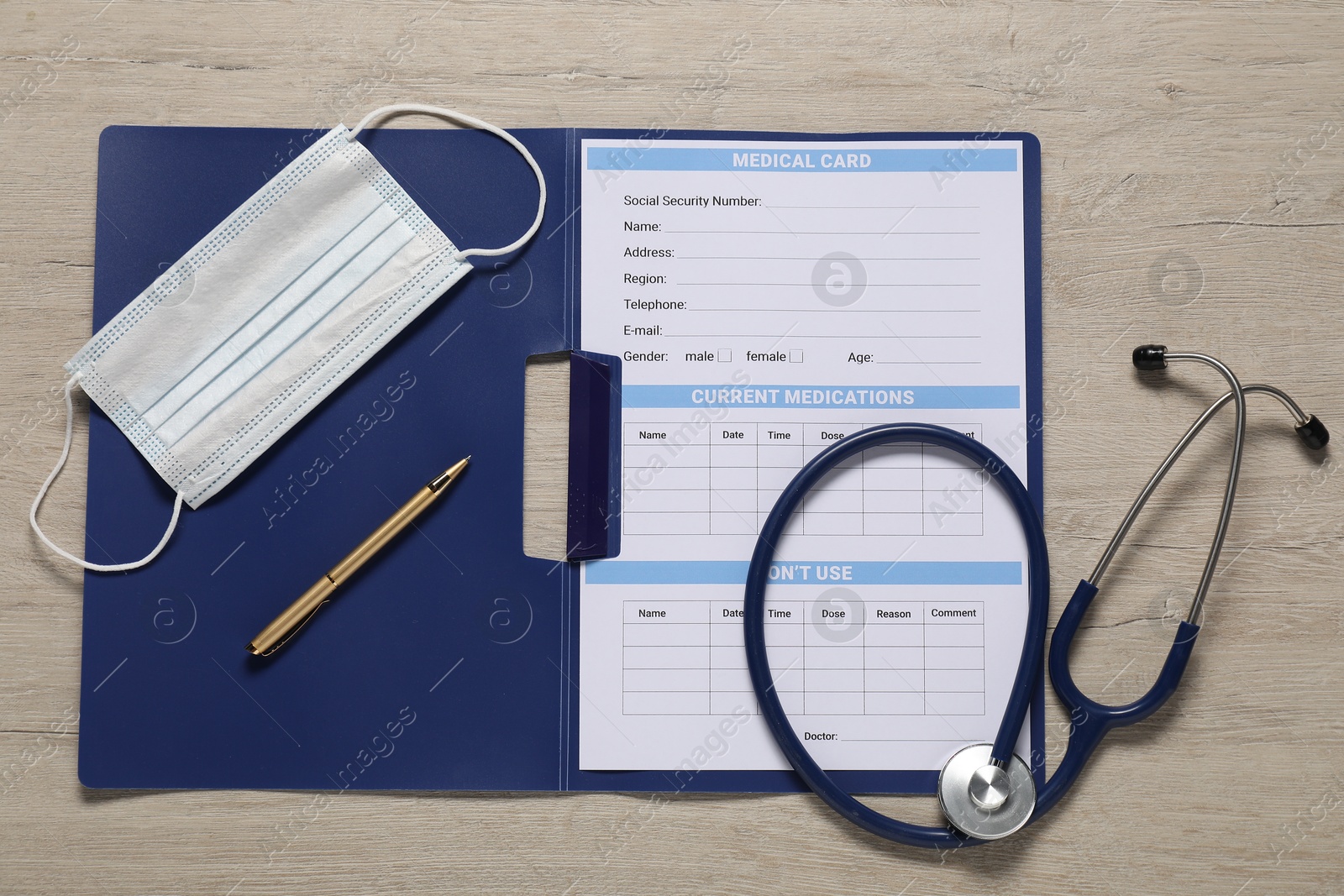 Photo of Flat lay composition with medical card form on light wooden background