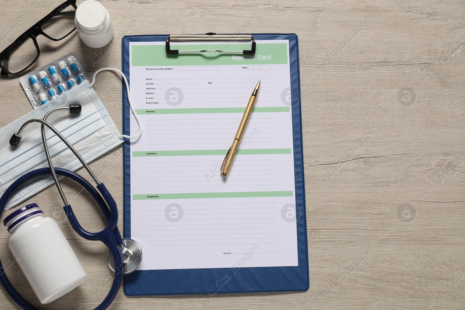 Photo of Flat lay composition with medical card form on light wooden background