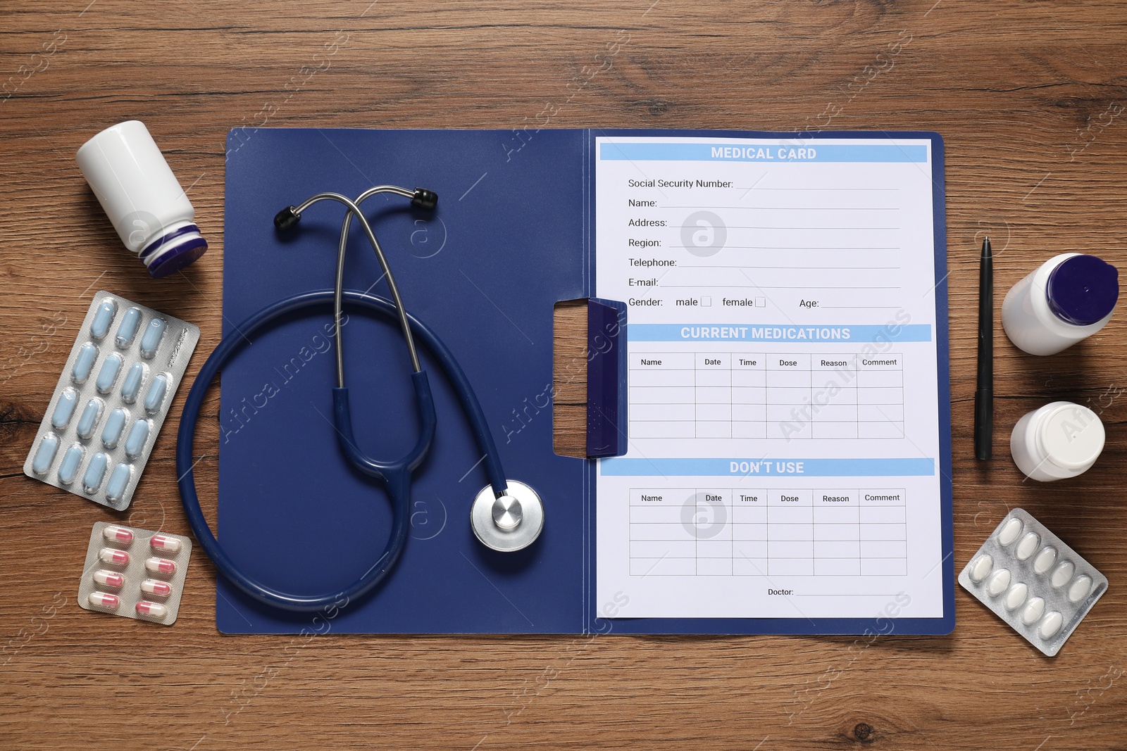 Photo of Flat lay composition with medical card form on wooden background