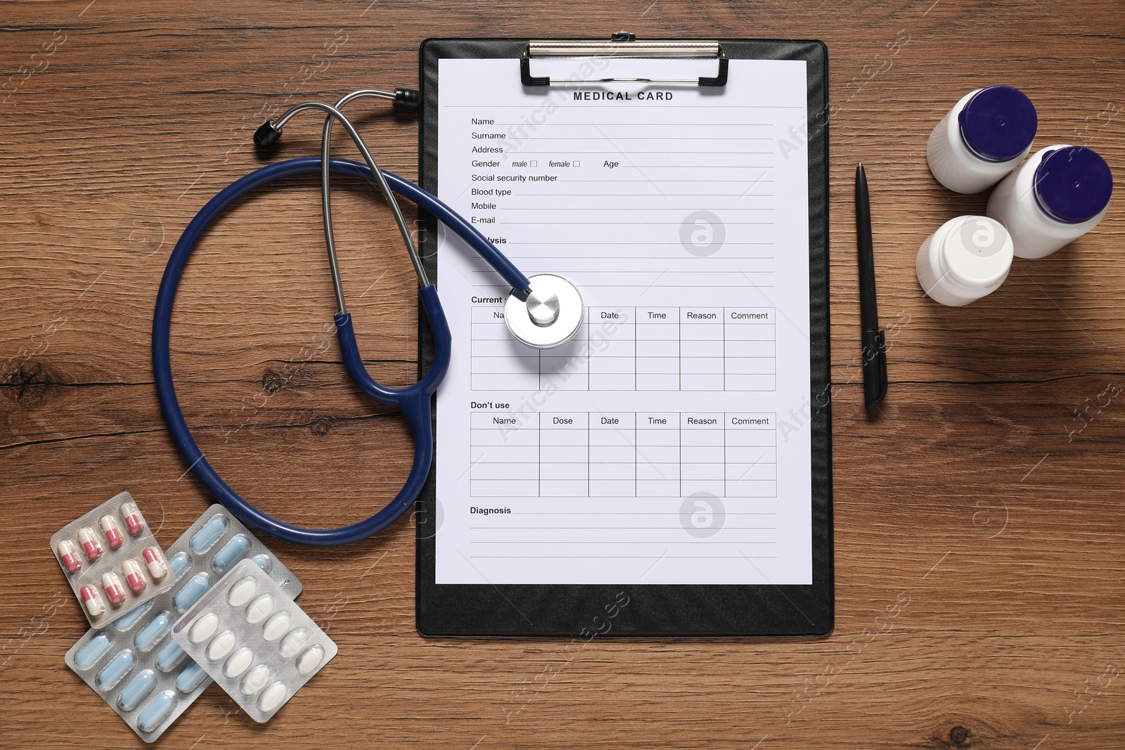 Photo of Flat lay composition with medical card form on wooden background