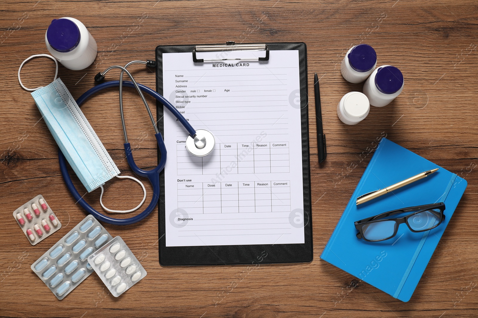 Photo of Flat lay composition with medical card form on wooden background